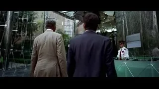 Men in suits with police officer in airport — Batman: The Dark Knight