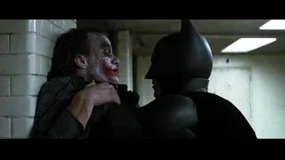 Joker covered in blood leaning on brick wall — Batman: The Dark Knight