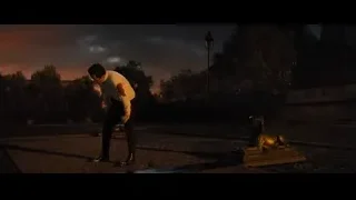 man standing by lion statue at night — John Wick: Chapter 4
