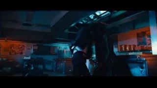 man in suit fighting in dark room — John Wick: Chapter 4