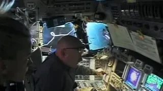 men in space station control room looking at Earth — Elon Musk: Return to Space