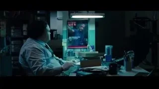 man in lab coat at desk with LIFE poster — The Secret Life of Walter Mitty