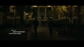 People walking at night in front of college building — The Social Network