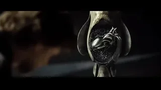 Hand holding small metallic object — Superman: Man of Steel