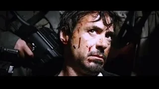 men with guns, one with bloody face — Iron Man