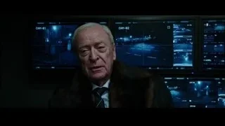 Elderly man in fur coat with multiple monitors — Now You See Me 2