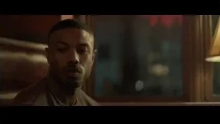 man speaking into microphone on bar screen — Creed 2