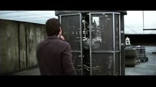 Man in suit with gun looking at Batman — Batman: The Dark Knight