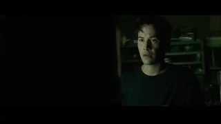 Young man standing in dimly lit room — The Matrix