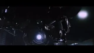 robot with glowing blue eyes in dark room — Iron Man