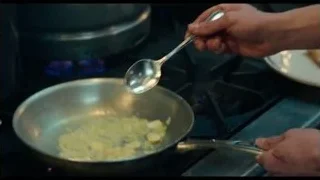 hands cooking on gas stove with flames — The Bear