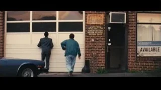 men in front of garage door with hands up — The Wolf Of Wall Street