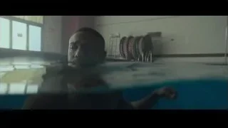 Man in pool holding goggles — Creed 2