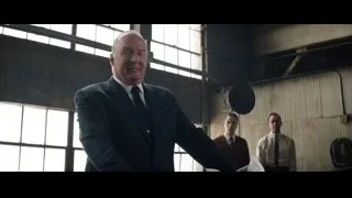 man in suit in industrial space — Ford v Ferrari