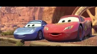 two Cars characters parked by red rock formation — Cars