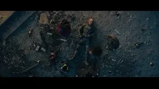 group of people around man lying in debris — Deadpool 2
