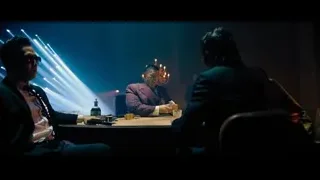 Three men at poker table in dimly lit room — John Wick: Chapter 4