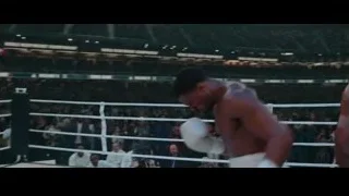 Two boxers fighting in ring with crowd — Creed 3