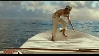 Man standing on surfboard in ocean — Life of Pi
