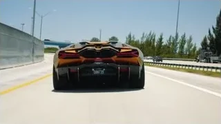 man giving speech on stage to audience — Sports Cars