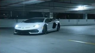 White Lamborghini parked in parking garage — Sports Cars