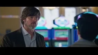 Man with beard in front of arcade machines — The Big Short