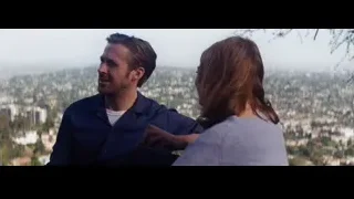 man gesturing to woman overlooking city — La La Land