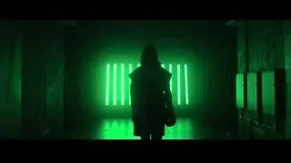 man in dark hallway with green neon lights — Creed 3