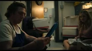 Man and woman looking at blue folder in kitchen — The Bear